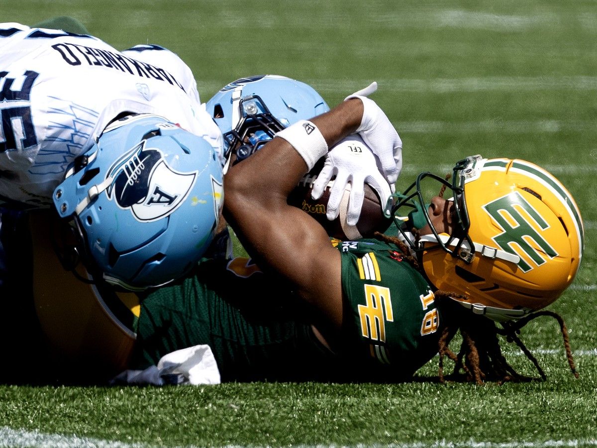 Edmonton Elks' Joshua Cephus (18) is tackled by the Toronto Argonauts' Isaac Darkangelo (35) and Adarius Pickett (6) during CFL action at Commonwealth Stadium, in Edmonton Saturday August 15, 2026.