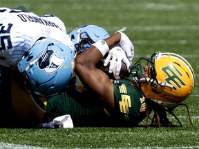 Edmonton Elks' Joshua Cephus (18) is tackled by the Toronto Argonauts' Isaac Darkangelo (35) and Adarius Pickett (6) during CFL action at Commonwealth Stadium, in Edmonton Saturday August 15, 2026.