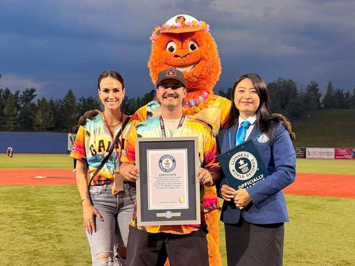 (Left to right) Cassandra Grodin, Co-owner of Cass and Nat Event Planning, Josh Iannetti, general manager of the Fort McMurray Giants and Tina Shi, Guinness World Record representative pose holding the world record title awarded to the Giants on August 1, 2026. Photo provided by Cassandra Grodin, Fort McMurray, Alta. August 10, 2026.