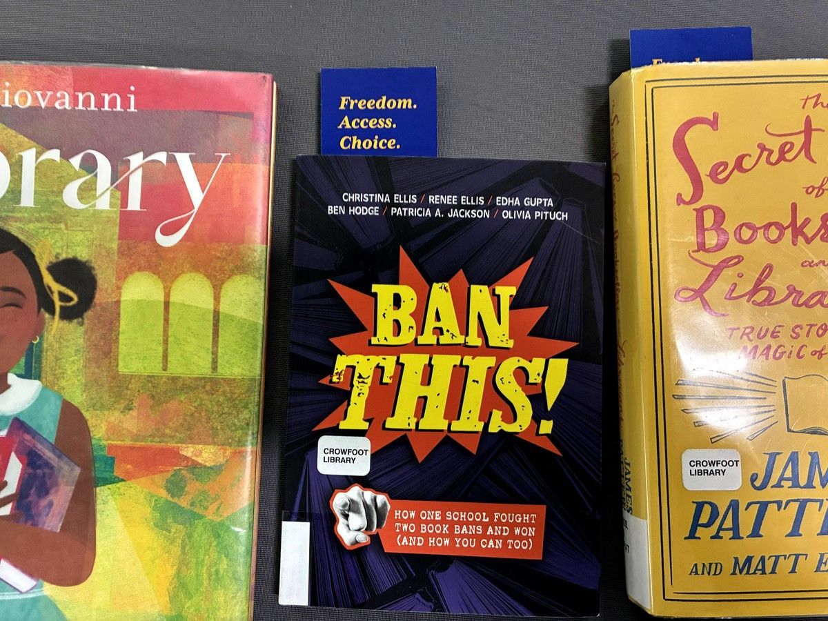 A table of books at the back of the Calgary Public Library's Crowfoot branch on August 14, 2026, raises awareness of access to materials.