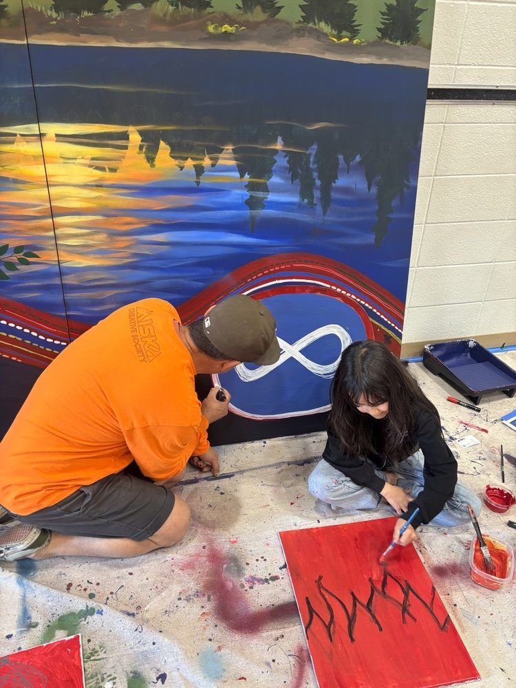 Artist Jesse Gouchey paints with a youth. Fort McMurray, Alta. August 20, 2026. Photo provided by RMWB.