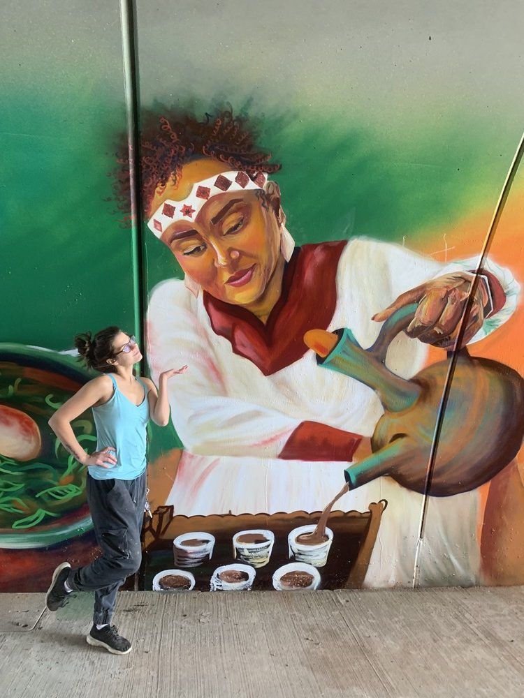 Artist Sara Litchi poses by a section of the Parson's mural. Fort McMurray, Alta. August 20, 2026. Photo provided by RMWB.