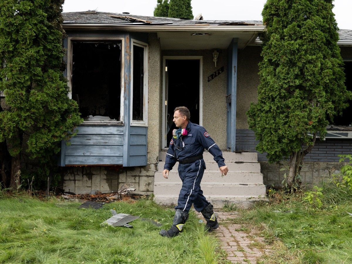 Fire investigators and police on the scene Monday at vacant home that will be knocked down for a multiplex