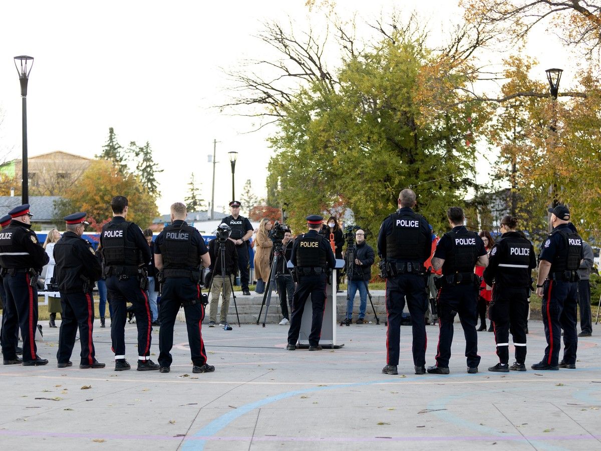 Members of the Edmonton Police Service speak about a reduction in crime and violence due to a focus on visible enforcement, during a press conference in Butler Memorial Park, Stony Plain Road and 158 Street, in Edmonton Wednesday Oct. 14, 2026.