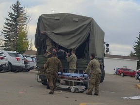 Canadian Armed Forces members move an injured comrade at Wainwright Hospital on Oct. 17, 2026.