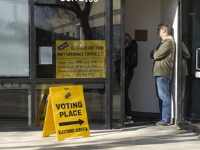 People line up to vote in the Alberta Referendum at Twin Atria in the early afternoon on Tuesday, October 13, 2026 in Edmonton.