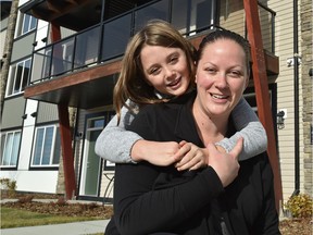 Jenna (no last name provided) and her daughter Anabelle, 9, received the keys to their new home from Habitat for Humanity's Carter Work Project in Edmonton on Monday, Oct. 23, 2017.