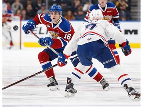 Davis Koch #16 of the Edmonton Oil Kings skates against Nolan Reid #7 of the Spokane Chiefs at Rogers Place on October 22, 2017 in Edmonton.