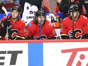 The Calgary Flames' Johnny Gaudreau, Jaromir Jagr and Sean Monahan sit together on the bench during NHL action against the Carolina Hurricanes at the Scotiabank Saddledome in Calgary on Thursday October 19, 2017.