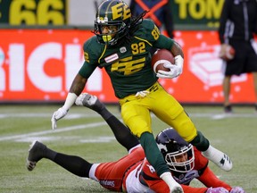 Edmonton Eskimos defensive tackle Da'Quan Bowers evades a tackle from Calgary Stampeders running back William Langlais during Canadian Football League game action in Edmonton on Saturday October 28, 2017.
