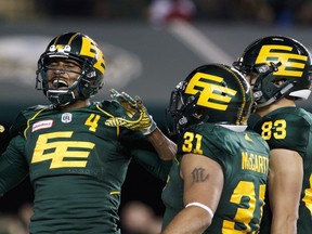 Edmonton Eskimos' Adarius Bowman (4) celebrates his touchdown against the Calgary Stampeders with teammates Calvin McCarty (31) and Brandon Zylstra (83) during second half CFL action in Edmonton, Alta., on Saturday October 28, 2017.