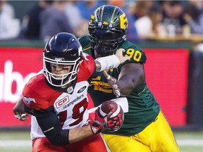 Calgary Stampeders quarterback Bo Levi Mitchell (19) gets sacked by Edmonton Eskimos' Almondo Sewell (90) during first half CFL action in Edmonton, Alta., on Saturday September 9, 2017.