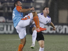 FC Edmonton midfielder Daryl Fordyce, right, battles with Miami FC defender Rhett Bernstein in North American Soccer League play at Riccardo Silva Stadium in Miami, Fla., on Saturday, Oct. 28, 2017.