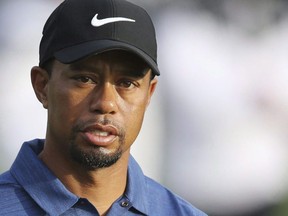 In this Feb. 2, 2017, file photo, Tiger Woods reacts on the 10th hole during the first round of the Dubai Desert Classic golf tournament in Dubai, U.A.E., on February 2, 2017.