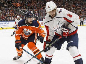 Washington Capitals forward Alex Ovechkin  battles for the puck with Edmonton Oilers defenceman Oscar Klefbom during NHL action in Edmonton on Oct. 28, 2017.