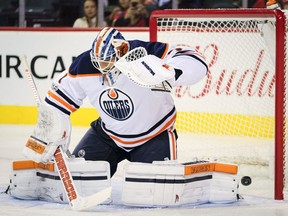 Edmonton Oilers goalie Laurent Brossoit lets in a goal during first period NHL preseason split-squad hockey action against the Calgary Flames in Calgary, Monday, Sept. 18, 2017.