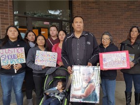 Jason Houle (centre) is seen with his family in front of Cold Lake provincial court Wednesday, Oct. 25, 2017.