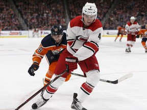 Edmonton's Anton Slepyshev battles Carolina's Haydn Fleury (4) during the second period of a NHL game between the Edmonton Oilers and the Carolina Hurricanes at Rogers Place in Edmonton, Alberta on Tuesday, October 17, 2017. Photo by Ian Kucerak Full Full contract in place Ian Kucerak, Ian Kucerak/Postmedia