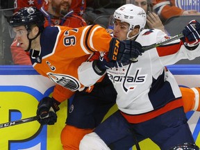 Edmonton Oilers Connor McDavid (left) is checked by Washington Capitals Jakub Vrana (right) during National Hockey League game action in Edmonton on Saturday October 28, 2017.