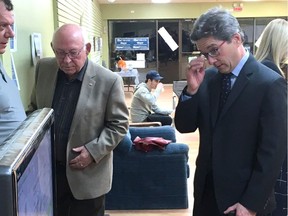 Victorious Strathcona County mayoralty candidate Rod Frank, right, watches election results at his campaign headquarters on Monday, Oct. 16, 2017.