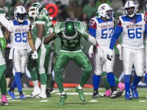 The Roughriders' Crezdon Butler celebrates one of his two sacks on Friday.