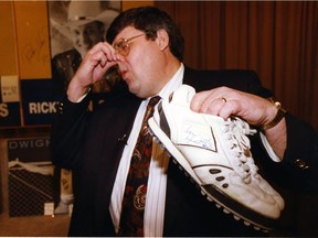 Sports columnist Terry Jones hams it up on Dec. 9, 1991, with a pair of Tracy Ham sneakers worn in the CFL western final. The shoes were being auctioned off for the Christmas Bureau.