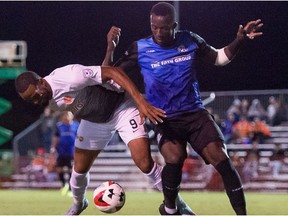 FC Edmonton defender Abdoulaye Diakite, right, battles for the ball with Puerto Rico FC striker Hector Ramos in North American Soccer League play in at Austin Tindall Park in Kissimmee, Florida on Wednesday, Oct. 25, 2017.