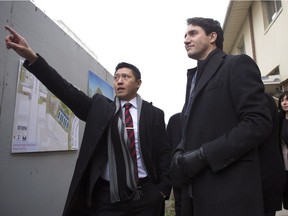 Prime Minister Justin Trudeau (right) stands with Jason Chen, Development Director at Toronto Community Housing as he visits a housing development in Toronto's Lawrence Heights neighbourhood ahead of a policy announcement, on Wednesday, Nov. 22, 2017.