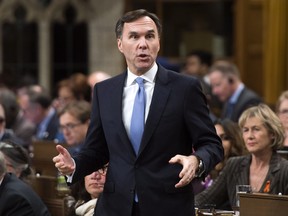 Finance Minister Bill Morneau stands during question period in the House of Commons on Parliament Hill in Ottawa on Monday, Nov. 27, 2017. THE CANADIAN PRESS/Sean Kilpatrick