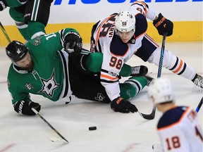 Martin Hanzal #10 of the Dallas Stars and Jesse Puljujarvi #98 of the Edmonton Oilers skate for the puck in the third period at American Airlines Center on November 18, 2017 in Dallas, Texas.