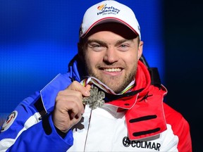 David Poisson holding his bronze medal at the 2013 Ski World Championships in Schladming, Austria.