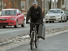 A cyclist rides on a designated bicycle lane on 102 Avenue near 117 Street in downtown Edmonton on Monday, Nov. 27, 2017.