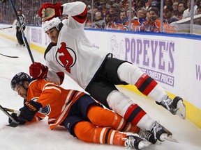 New Jersey Devils' Brian Boyle (11) checks Edmonton Oilers' Eric Gryba (62) during first period NHL action in Edmonton on Friday, November 3, 2017.