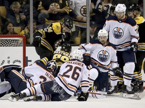 Boston Bruins left wing Jake DeBrusk (74) celebrates with teammate David Pastrnak (88) after Pastrnak scored a goal against Edmonton Oilers goalie Cam Talbot (33) during the first period of an NHL hockey game in Boston, Sunday, Nov. 26, 2017.