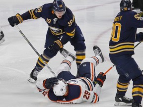 Buffalo Sabres defenseman Jake McCabe (19) checks Edmonton Oilers forward Leon Draisaitl (29) during the third period of an NHL hockey game, Friday Nov. 24, 2017, in Buffalo, N.Y.