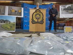 Staff Sgt. Karen Ockerman with the Edmonton Drug and Gang Enforcement (EDGE) Unit and Const. Jason Wells with the RCMP Clandestine Lab Enforcement and Response (CLEAR) Team show off the 130,000 fentanyl pills with an estimated street value of $2 million that were seized in a property search on July 5, 2017.