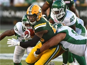 Edmonton Eskimos Pascal Lochard (25) about to be tackle by Saskatchewan Roughriders during CFL action at Commonwealth Stadium in Edmonton, August 25, 2017.