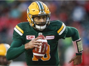 Edmonton Eskimos quarterback Mike Reilly runs with the ball during CFL action against the Toronto Argonauts in Edmonton on Oct. 14, 2017.