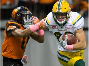 Edmonton Eskimos receiver Brandon Zylstra, right, fights off B.C. Lions' Loucheiz Purifoy during the first half of a CFL football game in Vancouver, B.C., on Saturday October 21, 2017.