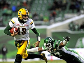 Edmonton Eskimos quarterback Mike Reilly runs the ball against Saskatchewan Roughriders' Rakim Cox during first half CFL football action at Mosaic Stadium in Regina on Saturday, November 4, 2017.