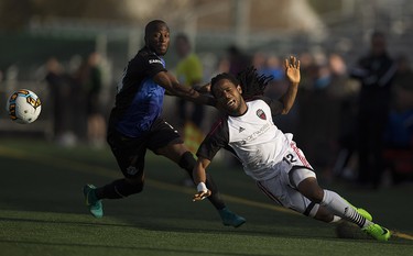 FC Edmonton's Sainey Nyassi and Ottawa Fury FC's Andrae Campbell battle for the ball during the Canadian Championship quarterfinal game on Wednesday May 10, 2017, in Edmonton. Greg  Southam / Postmedia
