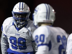 Harry Ainlay Titans defensive end Lwal Uguak (99) drills with teammates ahead of provincials during an team practice at Clarke Stadium in Edmonton, Alberta on Thursday, November 23, 2017.