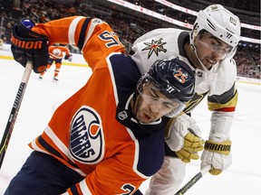 Vegas Golden Knights forward Alex Tuch and Edmonton Oilers defenceman Darnell Nurse battle in the corner during NHL action in Edmonton on Nov. 14, 2017.