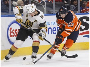 Vegas Golden Knights forward Cody Eakin (21) and Edmonton Oilers forward Ryan Nugent-Hopkins (93) battle for the puck during first period NHL action in Edmonton on Tuesday November 14, 2017.