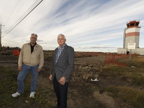 Mark Metzner, left, and Leigh Bond pose for a photo at the Blatchford site in Edmonton.