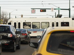 Traffic waits as a Metro Line LRT train crosses 107 Avenue at 105 Street in Edmonton on March 29, 2017.