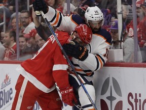 Detroit Red Wings defenseman Nick Jensen (3) and Edmonton Oilers left wing Jujhar Khaira (16) battle for the puck during the first period of an NHL hockey game, Wednesday, Nov. 22, 2017, in Detroit.