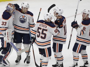 Edmonton Oilers goalie Cam Talbot (33) is congratulated by Mark Letestu (55) and teammates after their 6-2 win over the Detroit Red Wings in an NHL hockey game, Wednesday, Nov. 22, 2017, in Detroit.