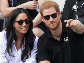 Britain's Prince Harry and his Meghan Markle attend the wheelchair tennis competition during the Invictus Games in Toronto on Sept. 25. Palace officials announced their engagement on Nov. 27.