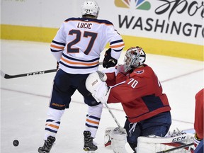 Washington Capitals goalie Braden Holtby (70) watches the puck against Edmonton Oilers left wing Milan Lucic (27) during the third period of an NHL hockey game, Sunday, Nov. 12, 2017, in Washington. The Capitals won 2-1 in a shootout.